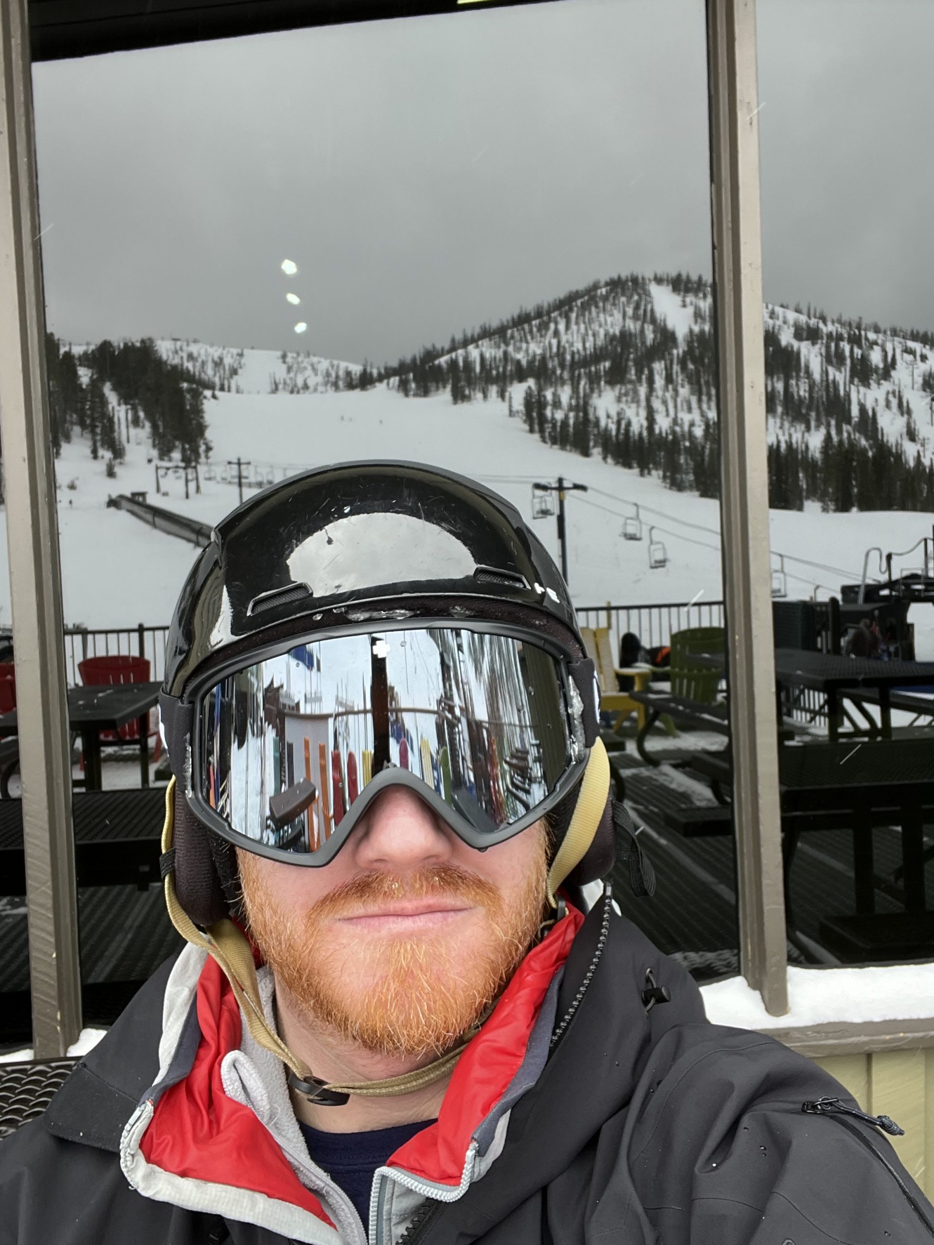 Phill Wolfe wearing a ski helmet in the mountains