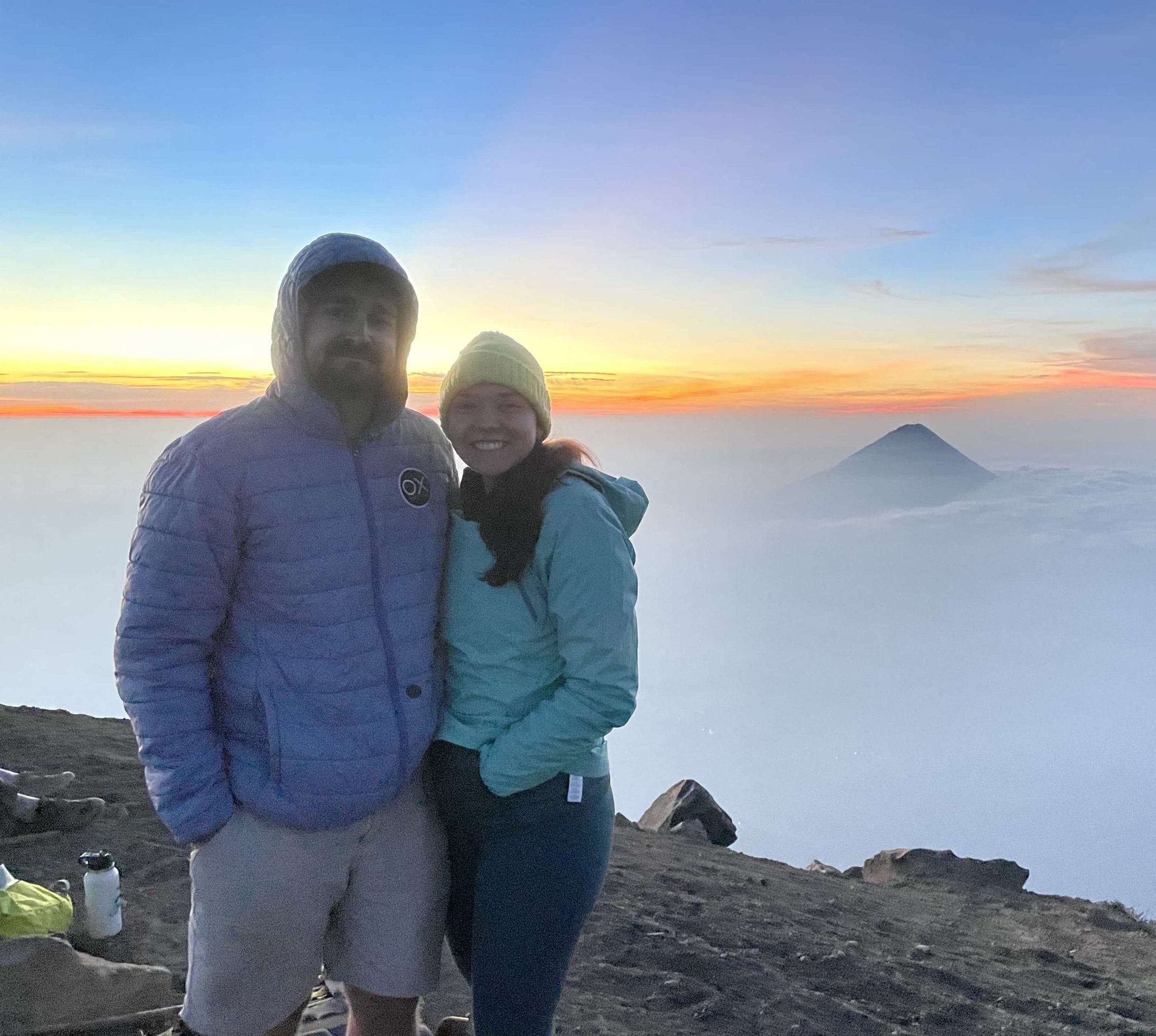 A shot of Caleb Rothwell next to his wife, standing on top of a mountain